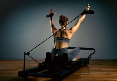 pilates-exercises-with-reformer-bed-beautiful-slim-fitness-trainer-fitness-concept